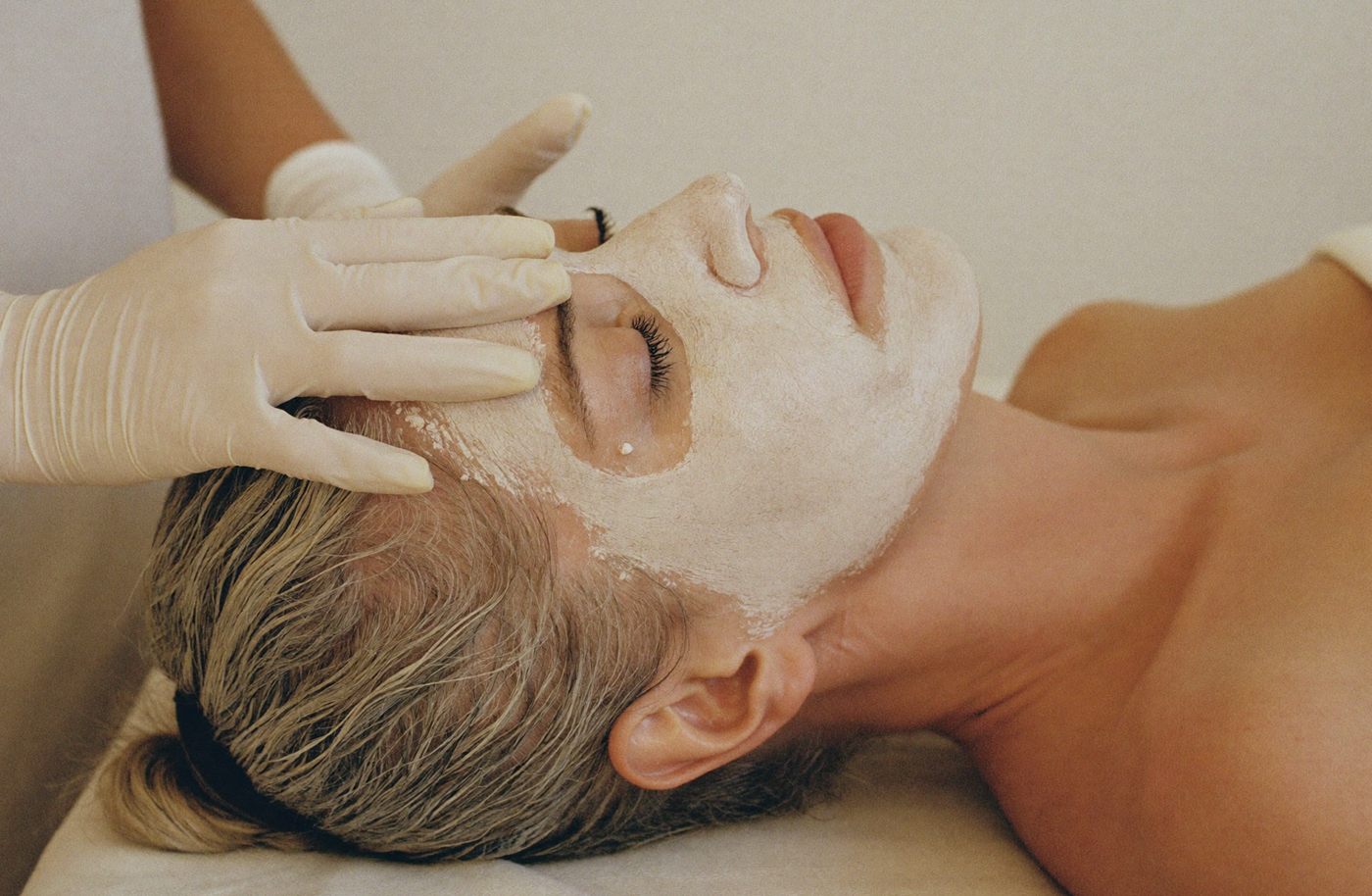 A facial rejuvenation treatment in progress, with a treatment mask being applied.
